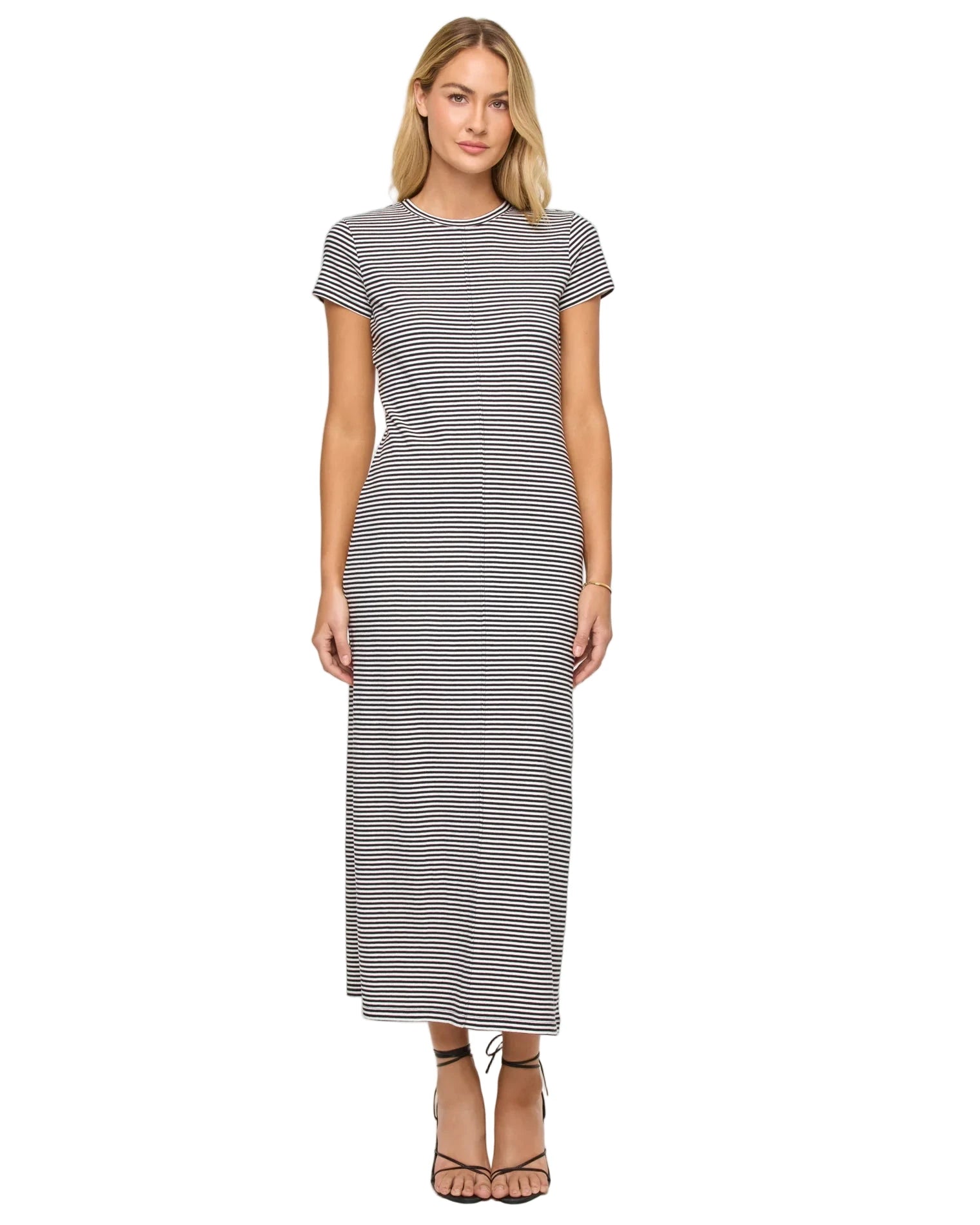 Woman wearing a black and white striped dress on a white background