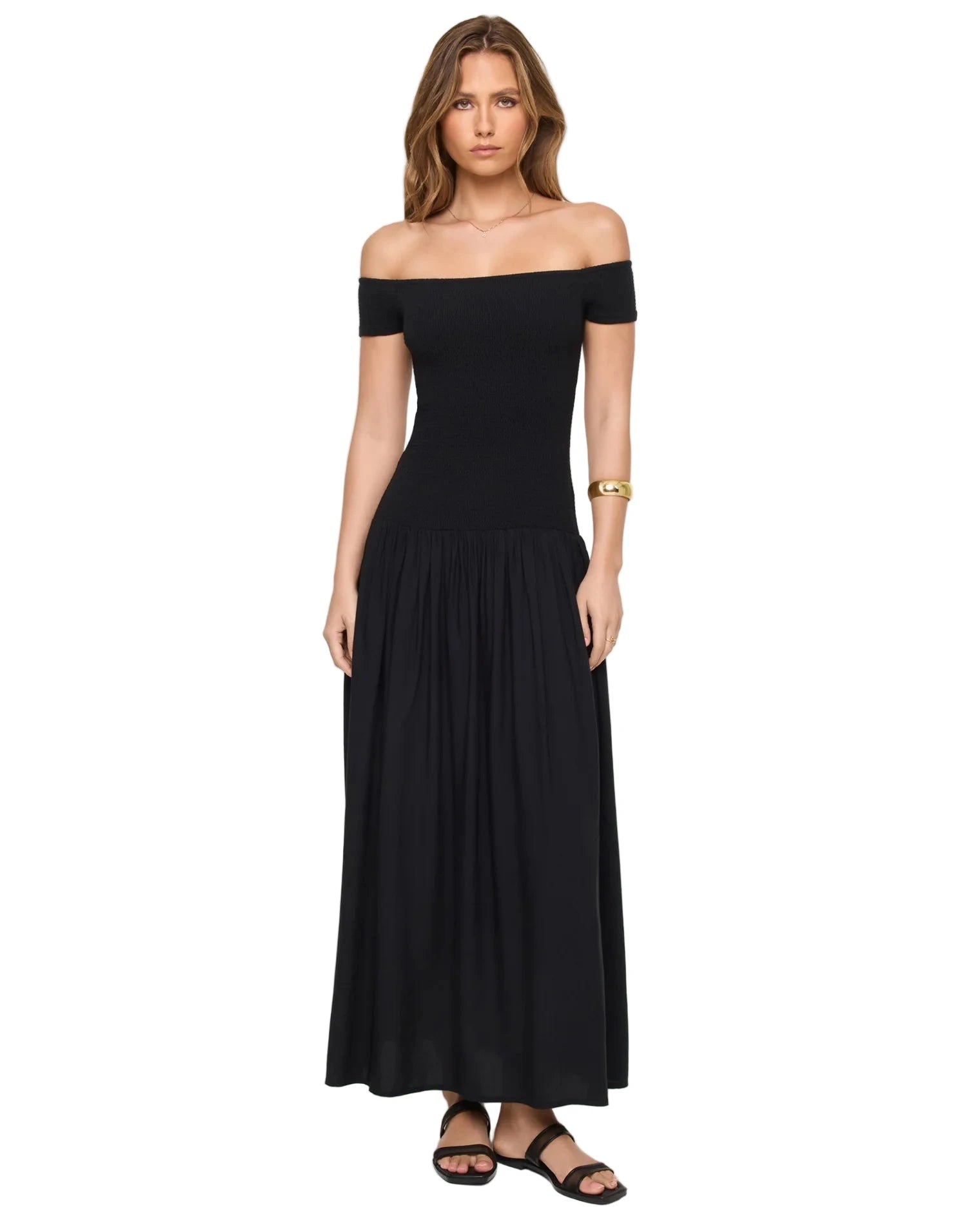 Woman wearing a black off-shoulder dress on a white background